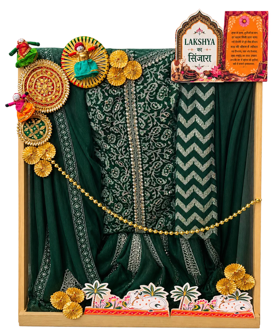 Green framed trousseau presentation with decorative puppets.